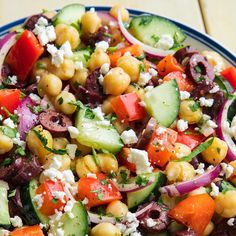 a salad with chickpeas, cucumbers, tomatoes and feta cheese