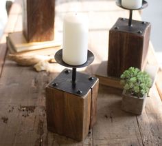 two candles sitting on top of wooden blocks