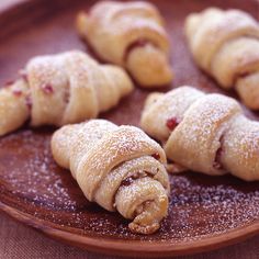 croissants on a plate with powdered sugar