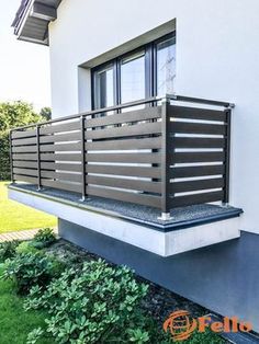 a balcony with metal railings on the side of a house