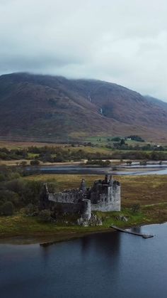 an old castle sitting on top of a small island in the middle of a lake