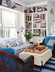 a living room filled with furniture and bookshelves covered in lots of bookcases