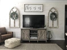 a living room with a cat sitting on the floor in front of a flat screen tv