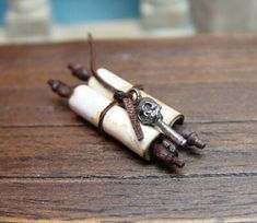 two small white candles are wrapped in brown string