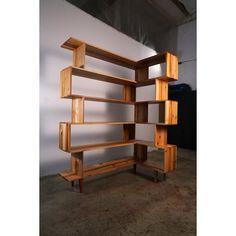 a wooden book shelf sitting on top of a carpeted floor