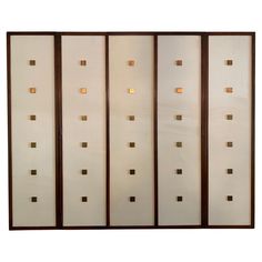 a room divider with four panels and lights on each panel, in white and brown