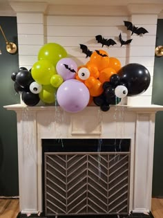 balloons and bats are hanging over the fireplace