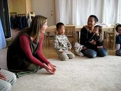 a group of people sitting on the floor in front of a tv