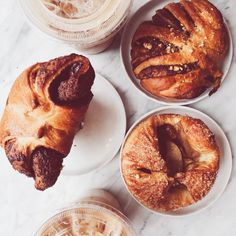 three plates with pastries on them sitting on a table