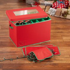 an open red box on the floor with christmas presents around it