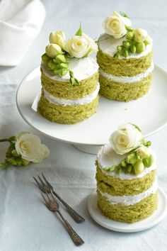 there are three cakes with flowers on the top and one has green frosting around it