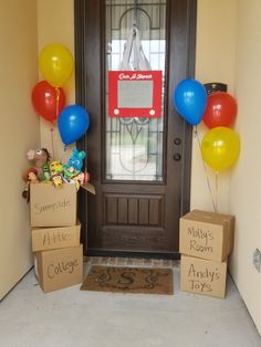 two boxes with balloons are sitting in front of a door