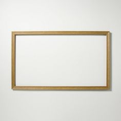 an empty wooden frame hanging on the wall