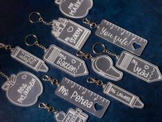 six clear plastic key chains with measuring tape and heart shaped tags attached to each one