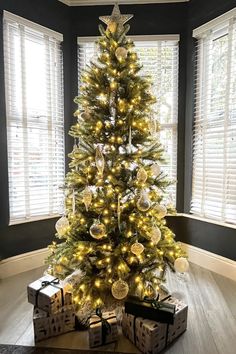 a christmas tree with presents under it