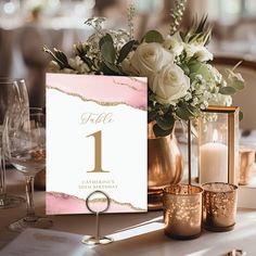 a table setting with candles and flowers in vases on the table number one card