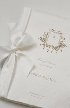 the wedding program is tied with a white ribbon