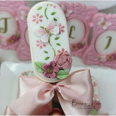 a close up of a cake with flowers on it and a ribbon around the top