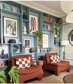 a living room filled with furniture and bookshelves covered in pictures on the walls