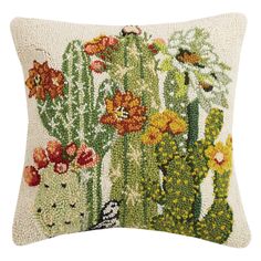 an embroidered cactus pillow with flowers on it