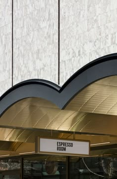 an entrance to a building with a sign that says espresso room