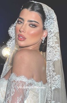 a woman wearing a wedding veil and makeup