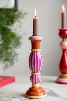 two candles are sitting next to each other on a table