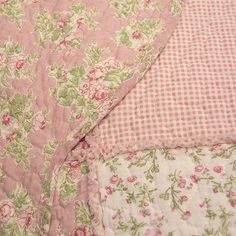 pink and green floral bedding with gingham checkerboard pattern on it