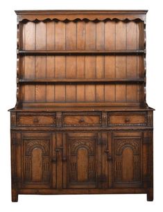 an old fashioned wooden cabinet with two doors and shelves on one side, the door is open