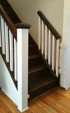 an empty staircase leading up to the second floor in a home with wood floors and white railings