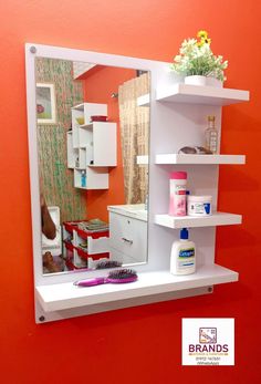 a bathroom mirror with shelves on the wall and a flower pot sitting on top of it