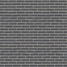 a brick wall that is made out of grey bricks