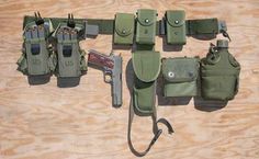 several different types of holsters laid out on a wooden surface