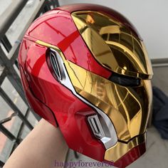 a person wearing a red and gold iron man helmet