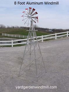 a windmill in the middle of a dirt field with text overlay that reads 8 foot aluminum windmill