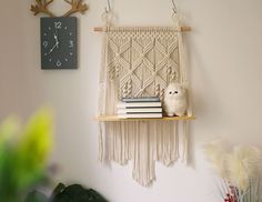 a shelf with books and a stuffed animal on it next to a wall hanging clock