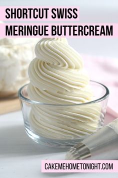 a glass bowl filled with meringue buttercream on top of a table