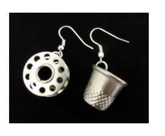 two silver cup earrings with holes on them