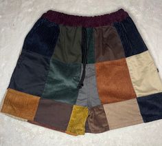 a multicolored shorts is laying on a white surface and it looks like they are made out of different fabrics