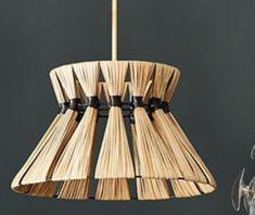 a wooden lamp hanging from a ceiling fixture