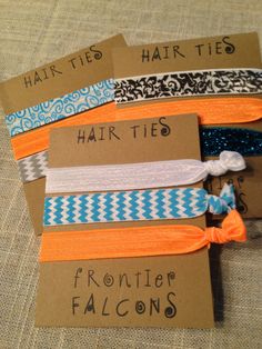 five hair ties with different designs on them sitting on top of a piece of cardboard