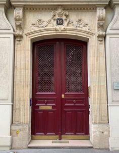 a large red door on the side of a building