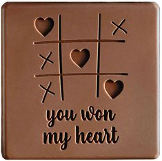 a chocolate plaque with hearts and ticquets on it that says, you won my heart