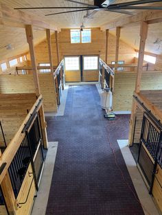 the inside of a horse barn with multiple stalls