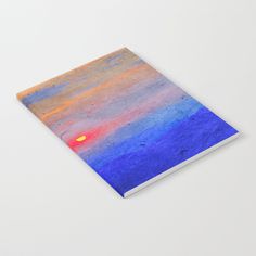 a notebook with an abstract painting on the front and back cover that is blue, orange, yellow, and pink