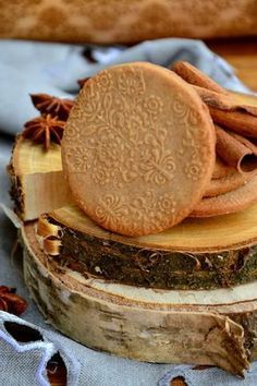 two cookies on top of each other with cinnamons and anise in the background