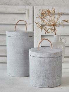 two cement containers sitting next to each other