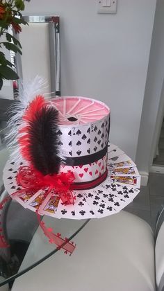 a white hat with black and red designs on it sitting on top of a table