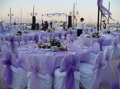 tables covered with purple sashes and chairs