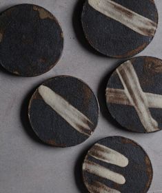 four black and white plates sitting on top of a table